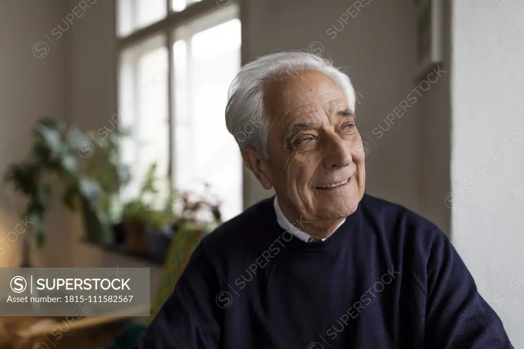 Smiling senior man at home