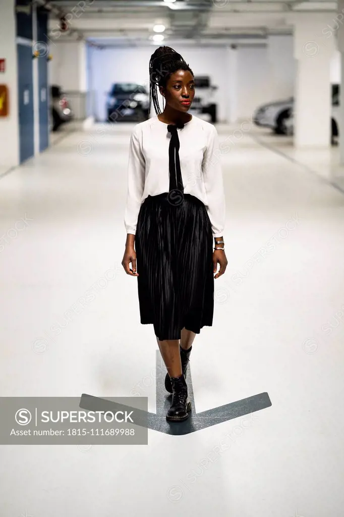 Elegant woman walking in car park