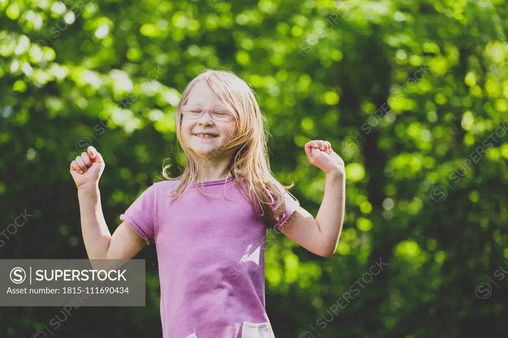 A jumping preschool girl with closed eyes