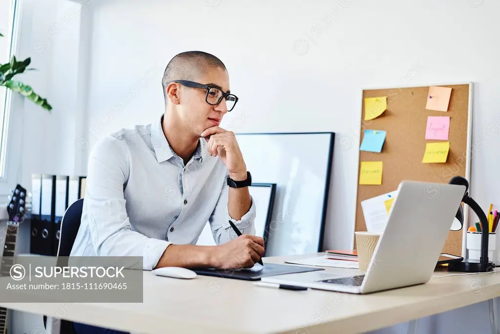 Portrait of graphic designer working in home office