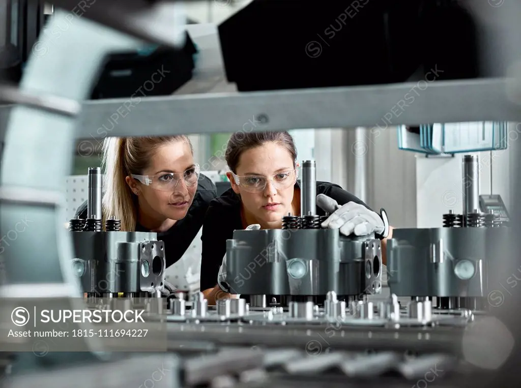 Young women checking production line on a conveyor belt