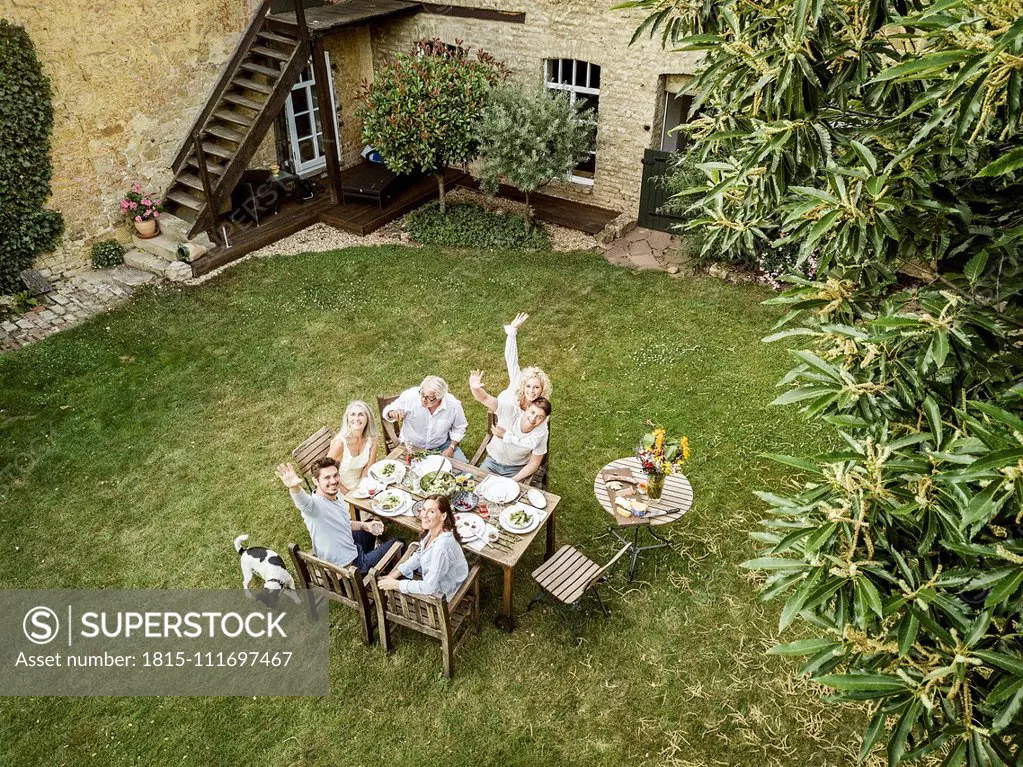 Family eating together in the garden in summer