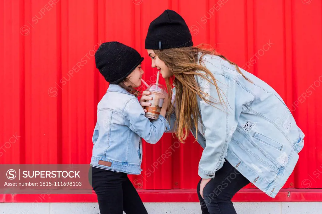 Teenage girl and little sister having fun together