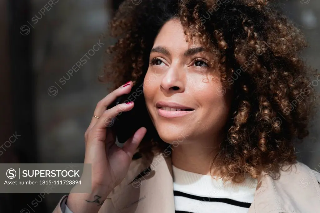 Portrait of smiling woman talking on cell phone