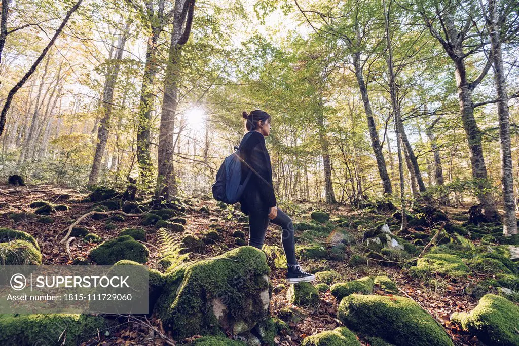 Spain, Navarra, Irati Forest, young woman standing in lush forest