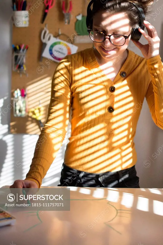 Woman painting and listening to music