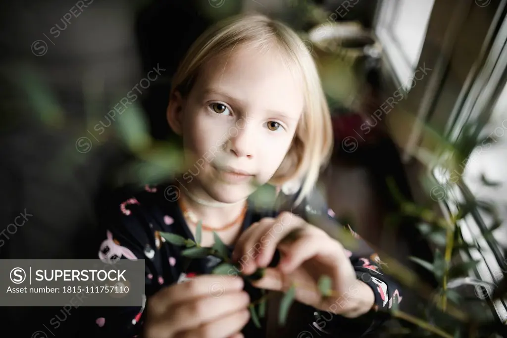 Portrait of blond little girl at home