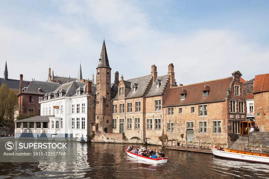 Belgium, Bruges, boat with tourists driving on Rozenhoedkaai