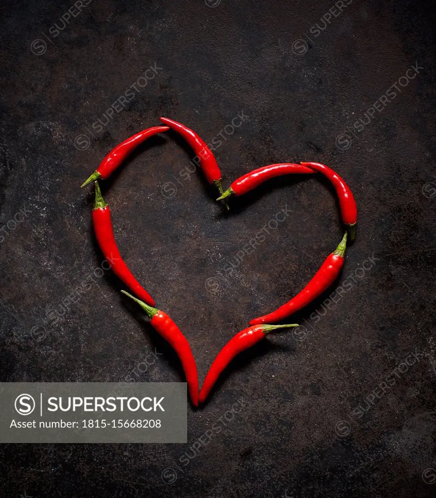 Red chili peppers arranged in heart shape