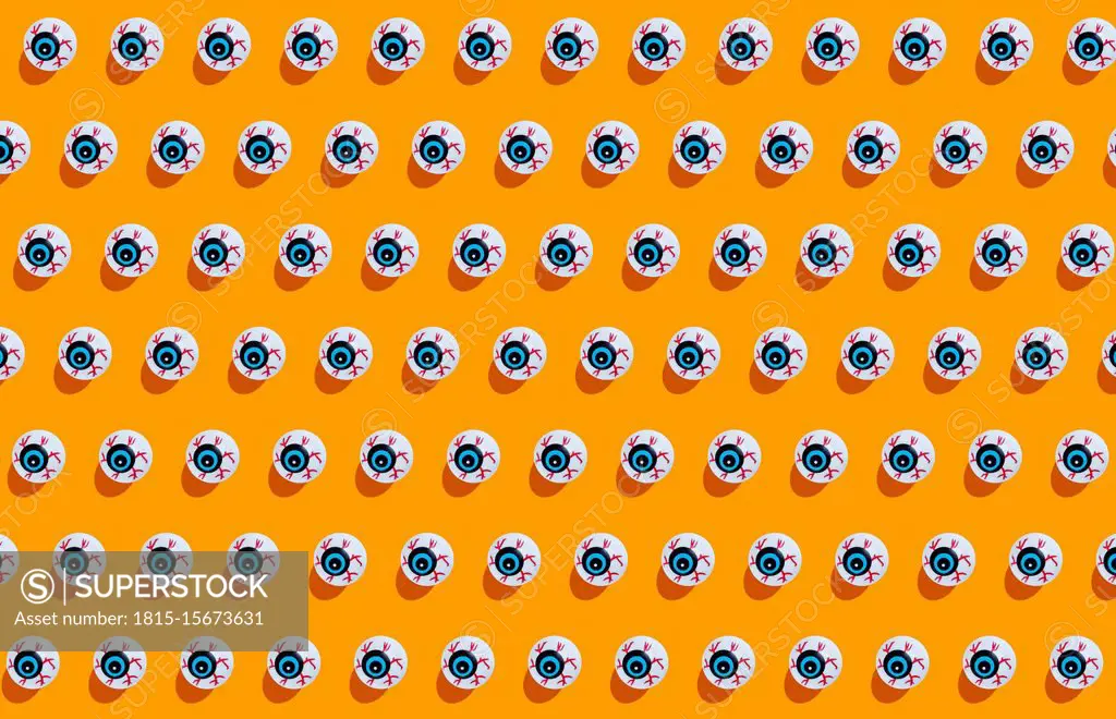 Fake scary eyeballs for halloween on orange background