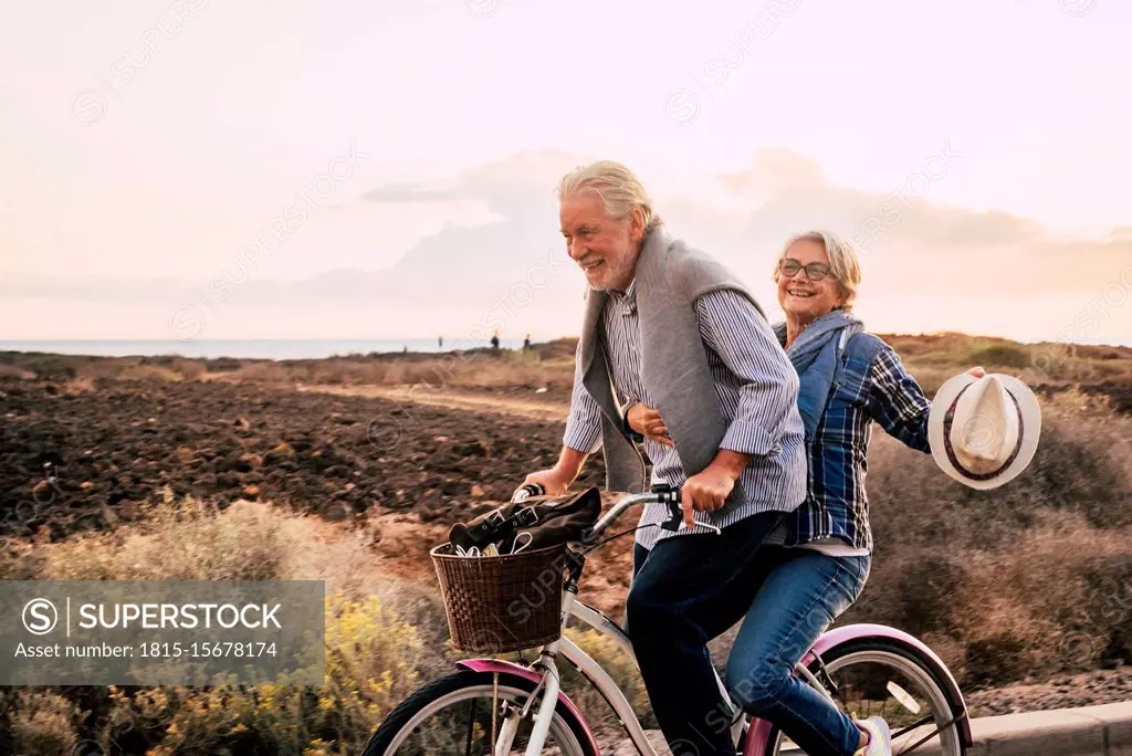 Happy active senior couple on bicycle, Tenerife