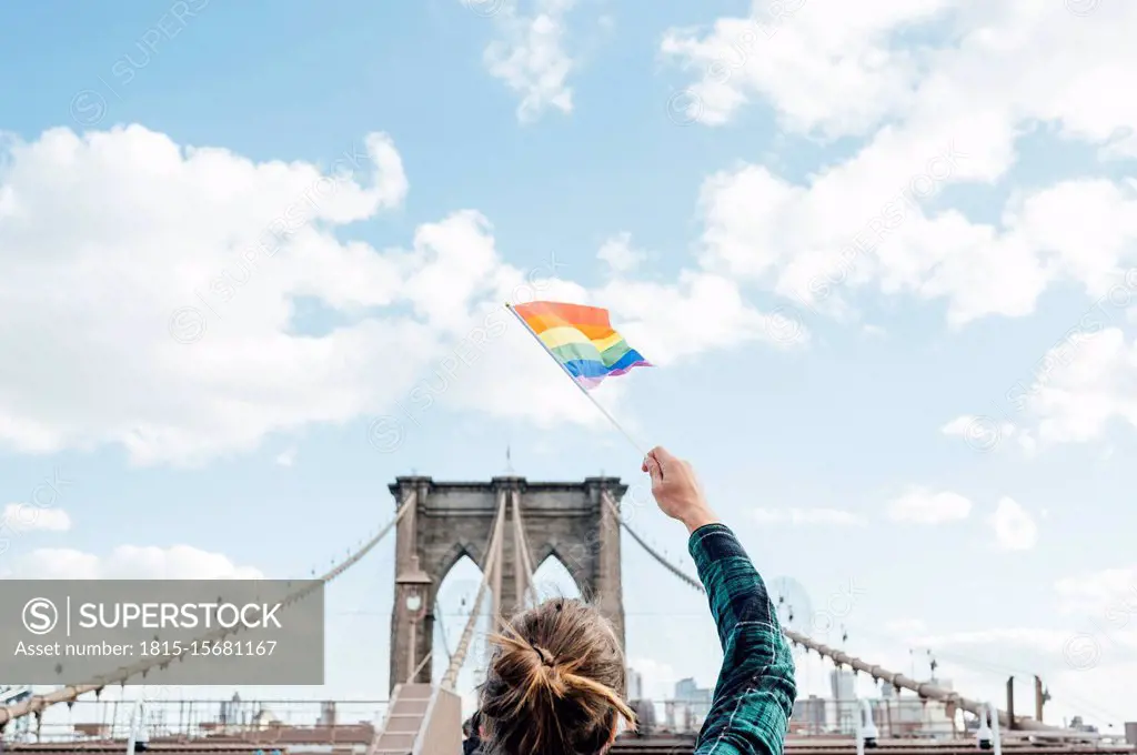 Woman waving LGBT flag in NYC, USA