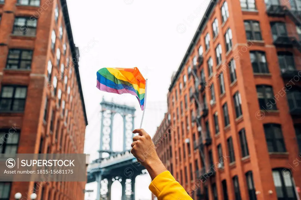 Hand waving LGBT flag in NYC, USA