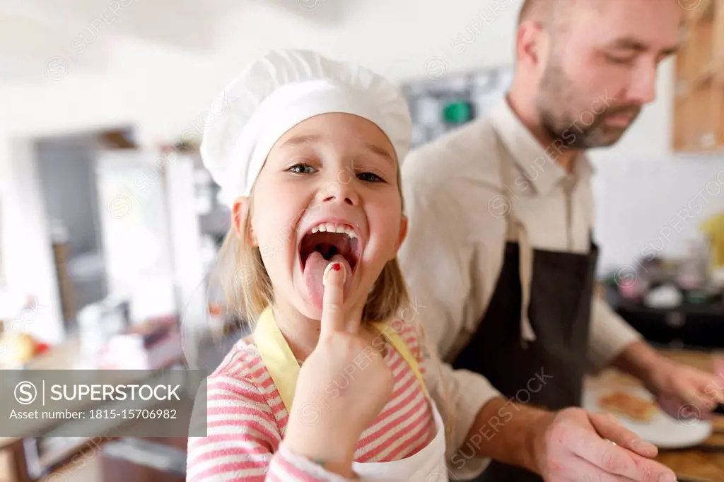 Father and daughter cooking in the kitchen