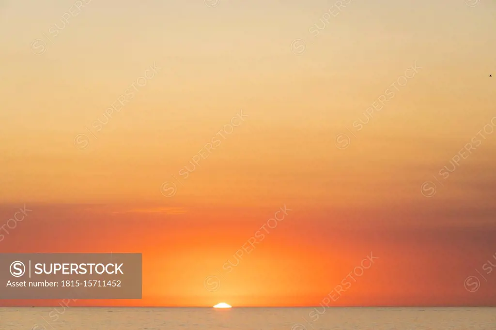 USA, California, Los Angeles, Moody orange sky over Pacific Ocean at sunset