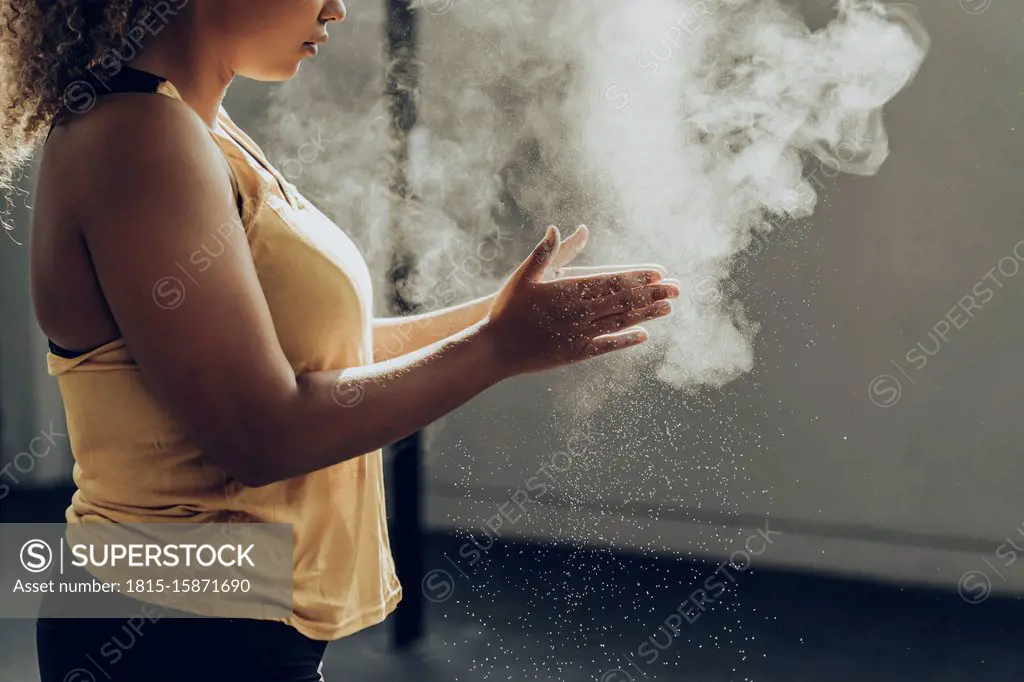 Athletic woman preparing for workout in gym