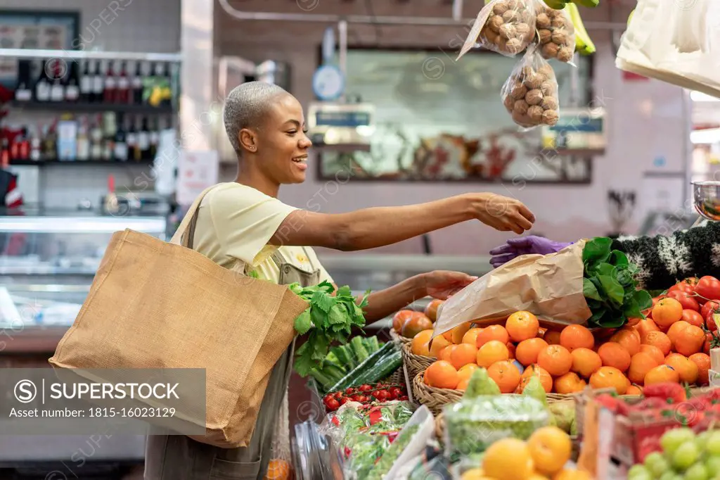 Woman buying groceries in a market hall