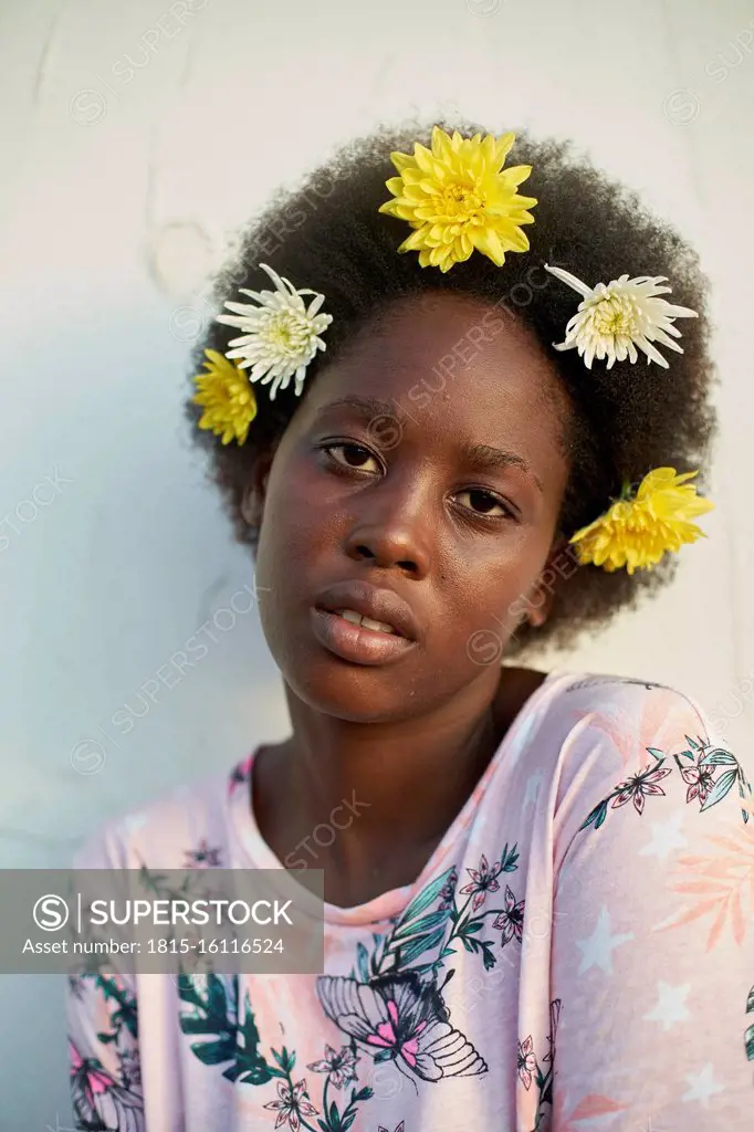 Portrait of young woman wearing flowers