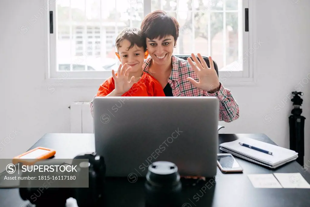 Mother and son using laptop for a video call at home
