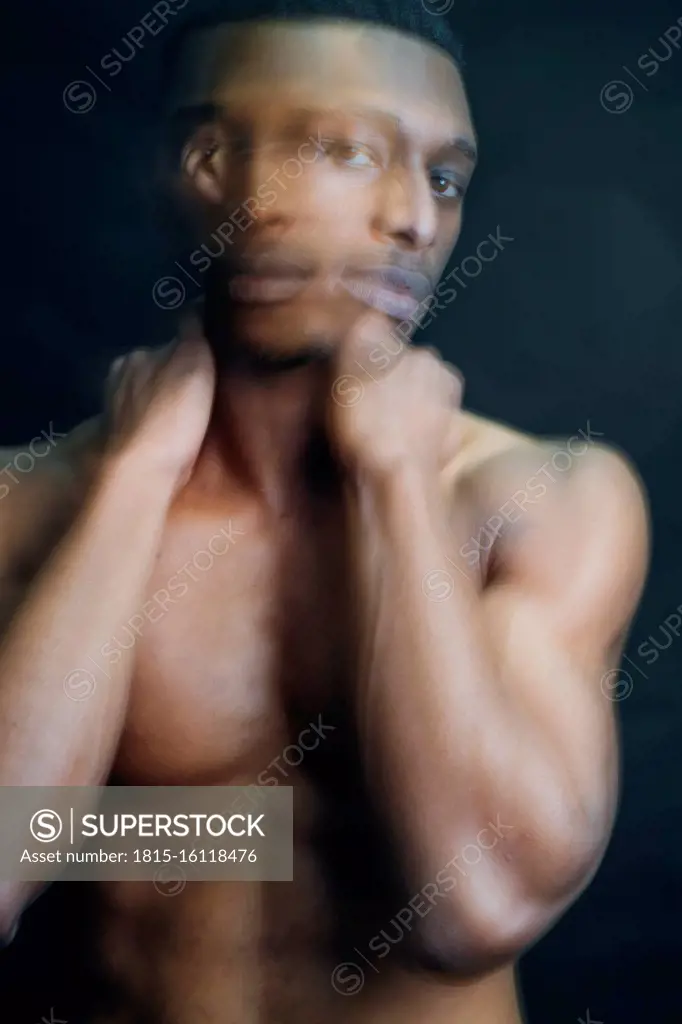 Double exposure portrait of nude young man in studio