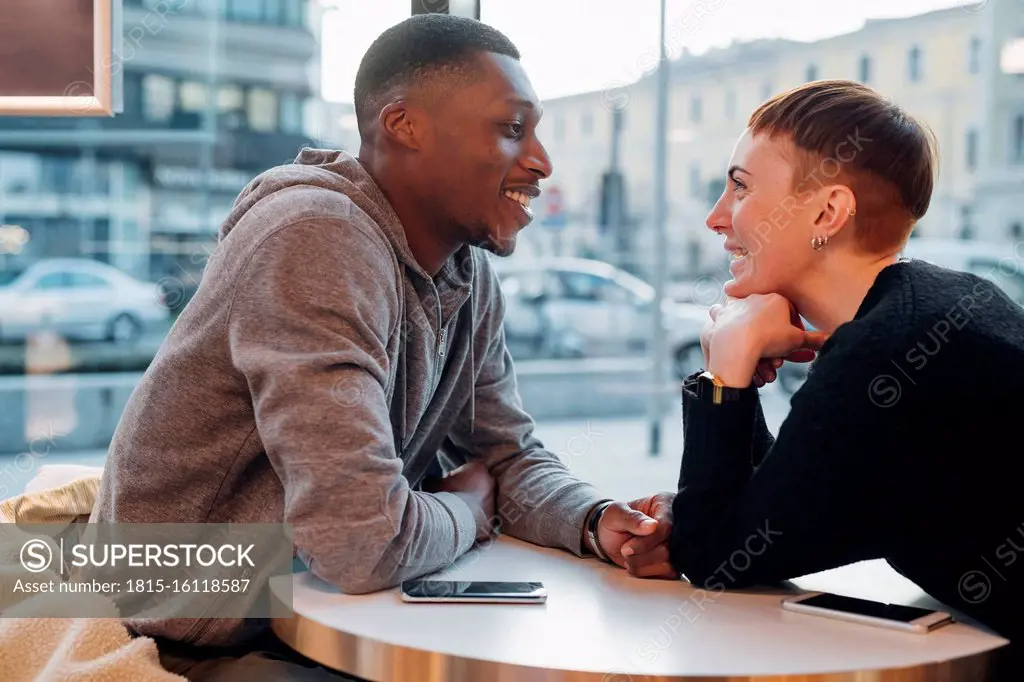 Smiling young couple in a cafe