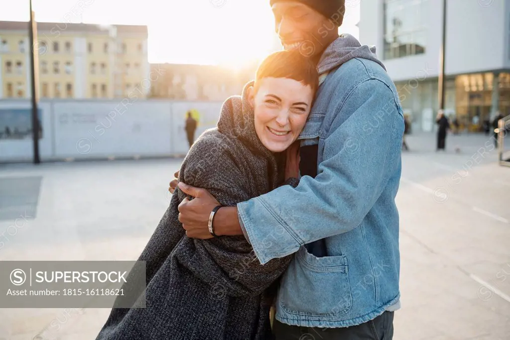 Happy young couple in the city at sunset