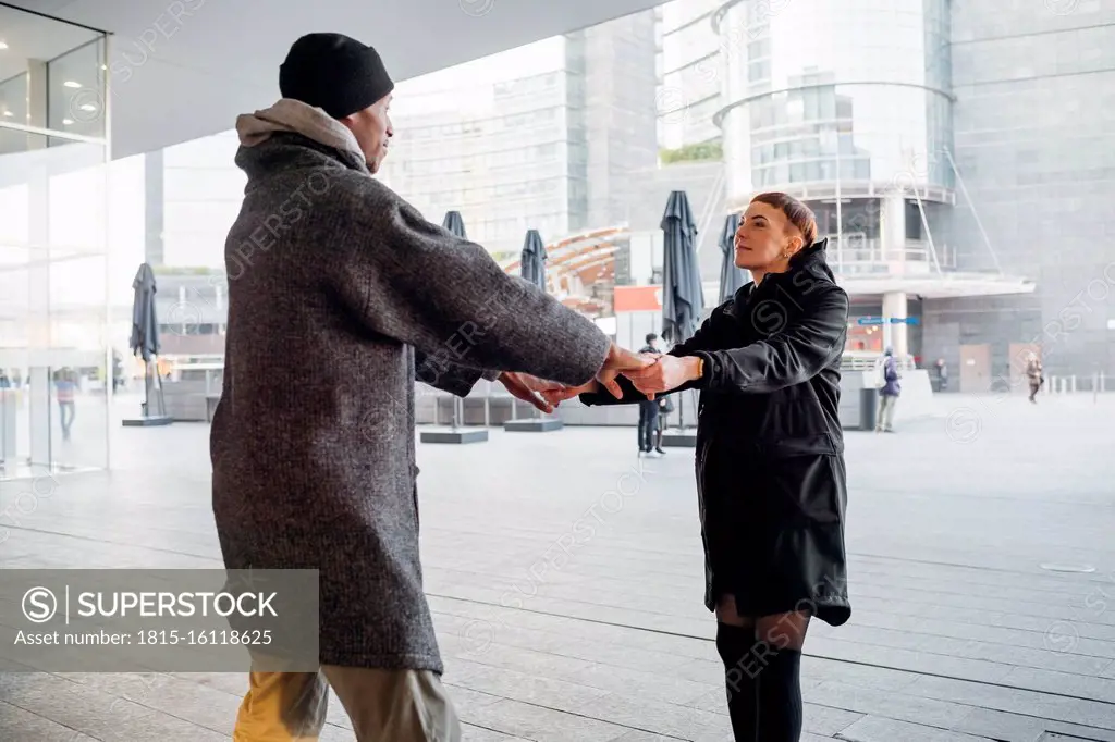 Young couple holding hands in the city