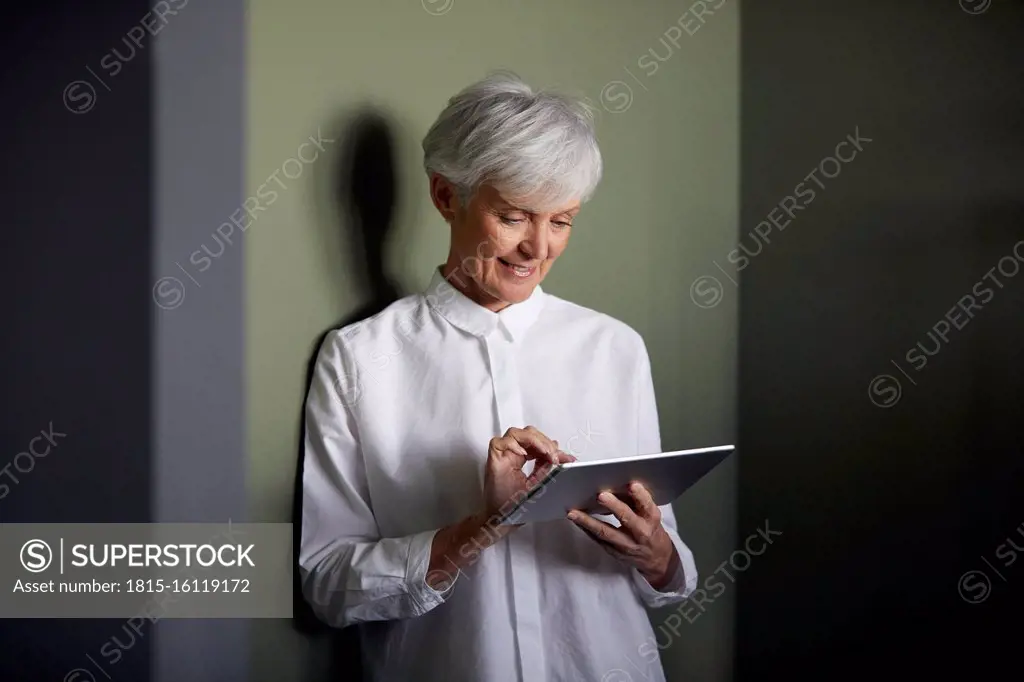 Portrait of senior businesswoman using digital tablet