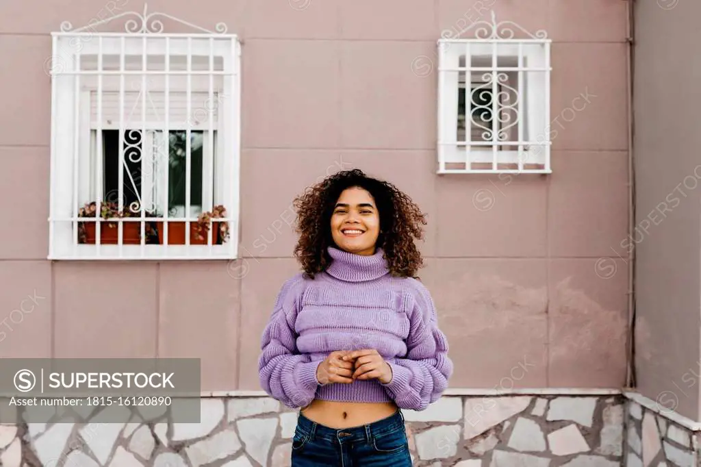 Portrait of smiling woman with windows in the background