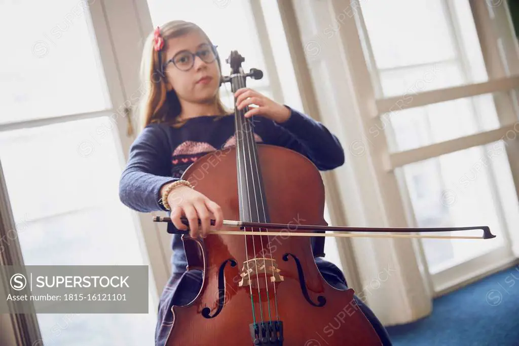 Girl playing cello during a lesson