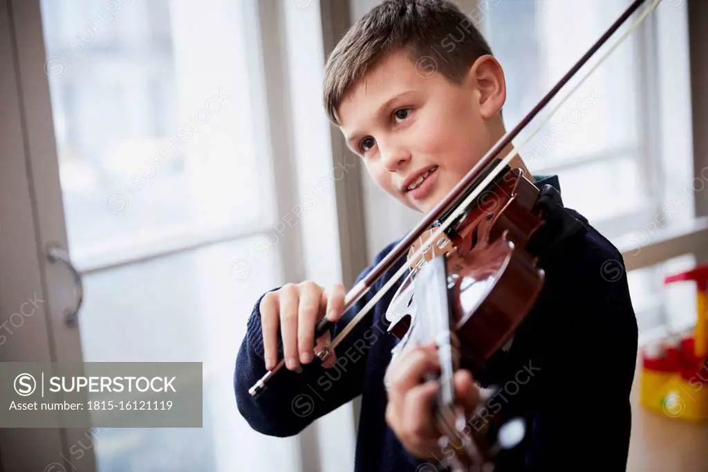 Boy playing violin during a lesson