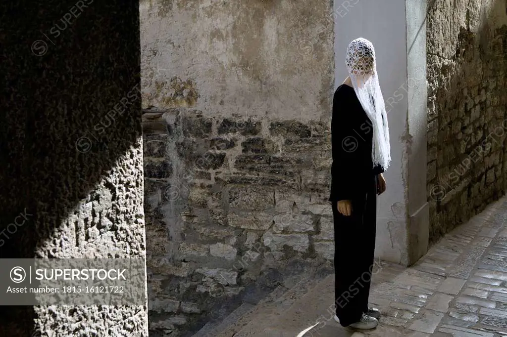 Woman dressed in black wearing crocheted white headdress with fringes, Rovinj, Croatia