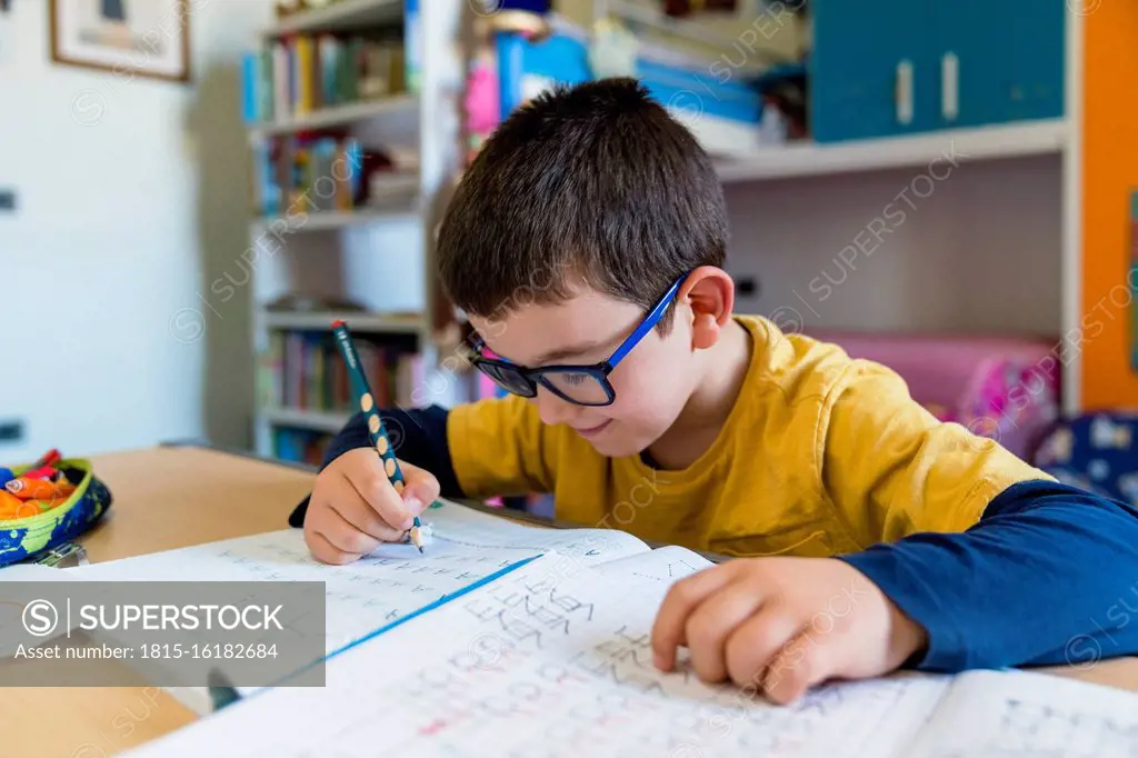 Elementary student learning while sitting at desk during homeschooling