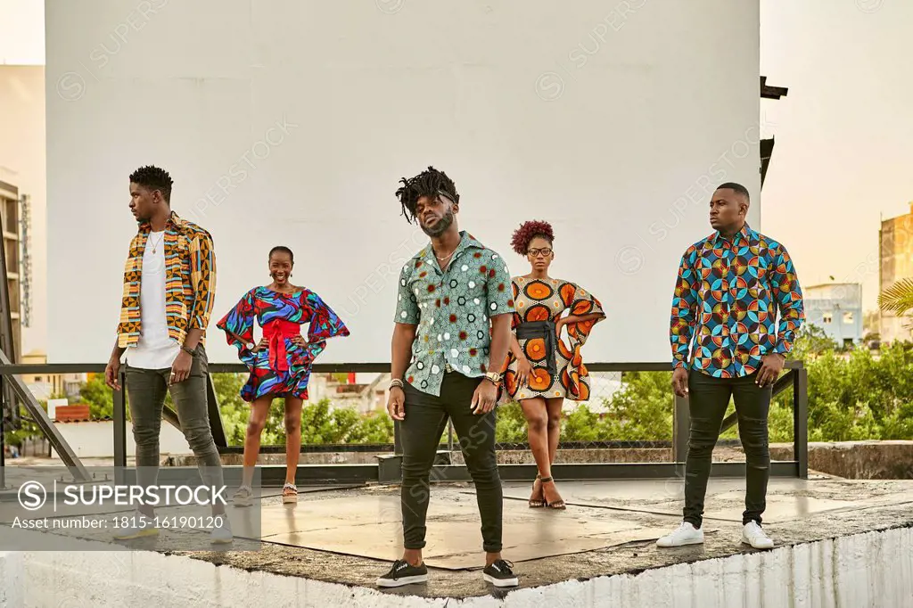 Friends in colorful clothes standing on roof terrace in the city, Maputo, Mozambique