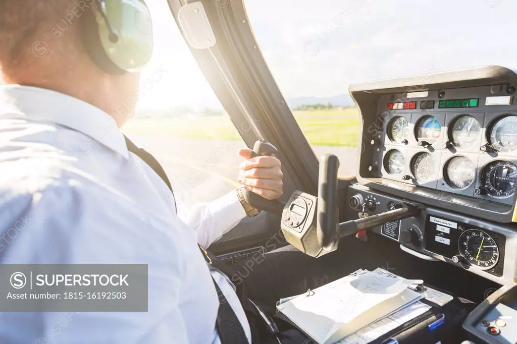 Pilot flying in sports plane, using control wheel