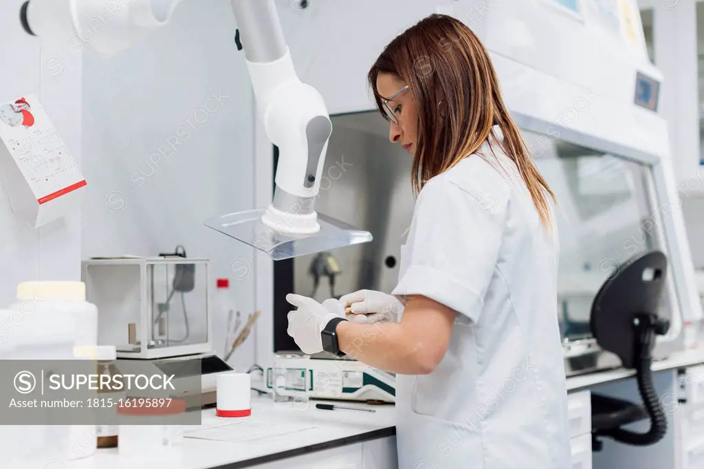 Confident female scientist working at laboratory