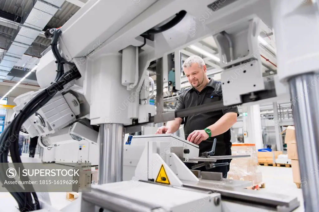 Man operating a machine in a factory