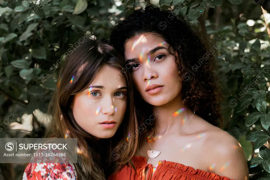 Two beautiful women embracing in nature