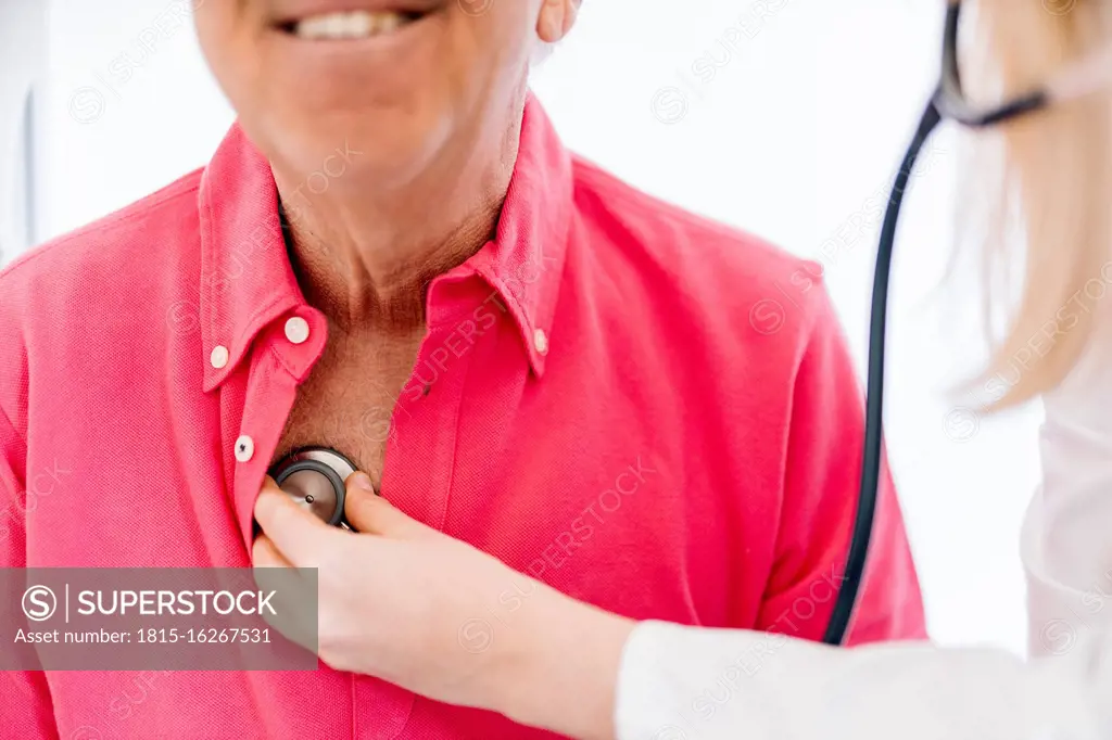 Female doctor examining senior patient in medical clinic