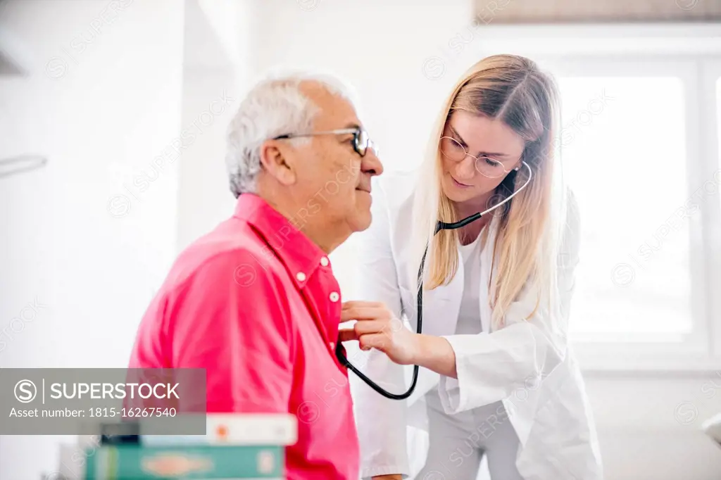 Female doctor examining senior patient in medical clinic