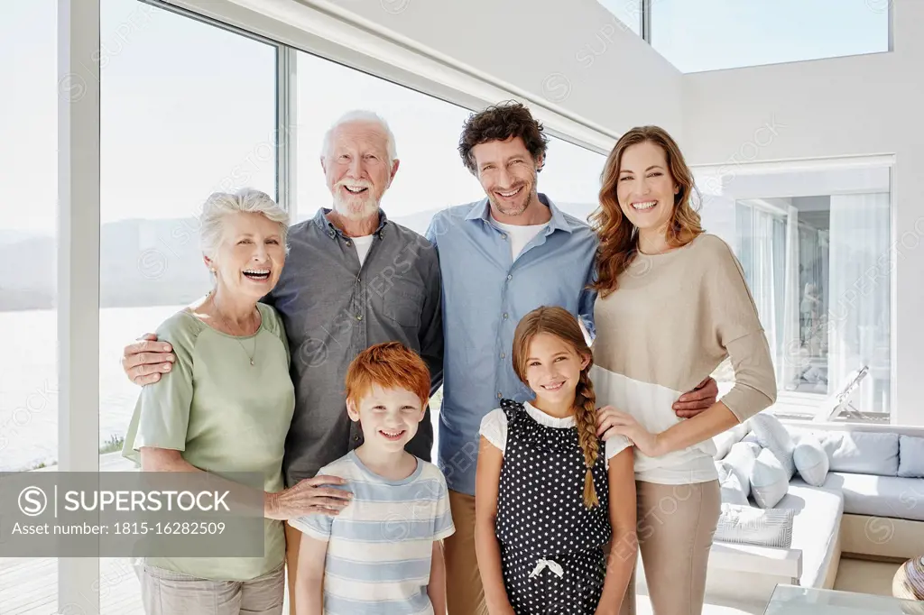 Portrait of happy multi-generation family in luxury villa