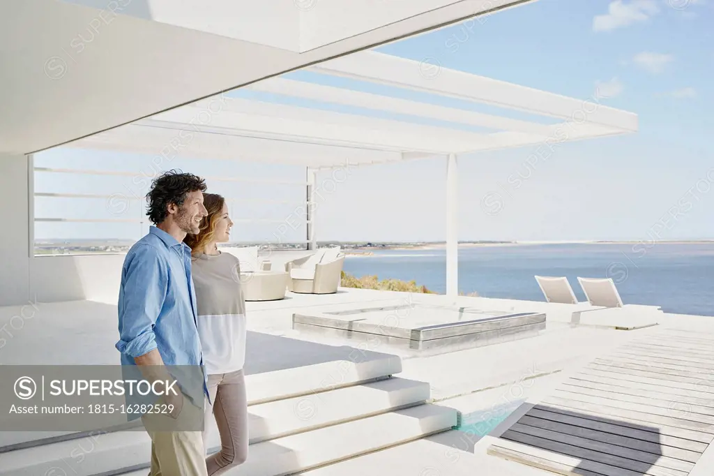 Couple at luxury beach house enjoying the view