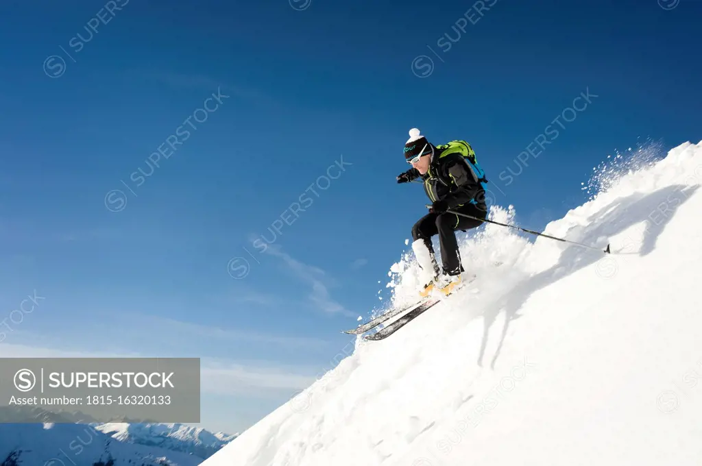 Austria, Man skiing on mountain at Alpbachtal