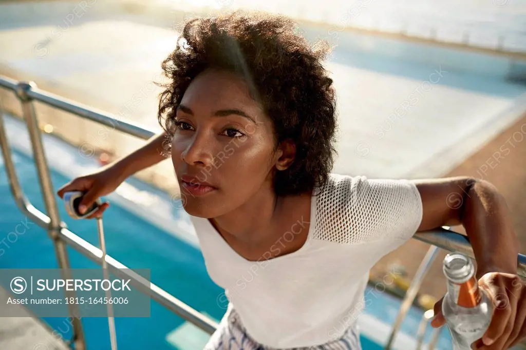 Young woman on highboard of swimming pool