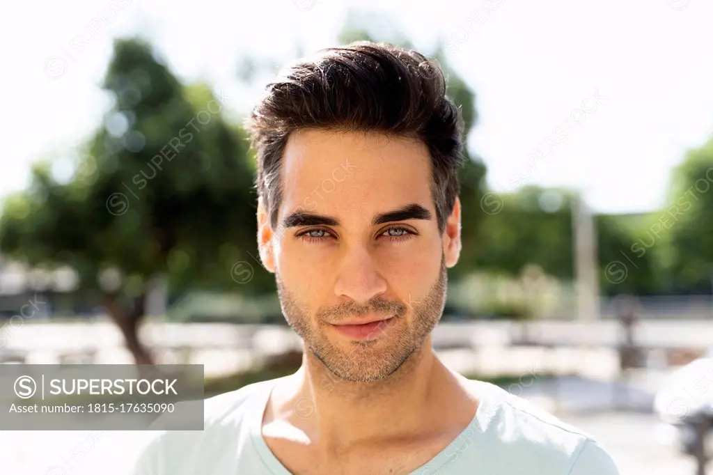 Confident man in city during sunny day