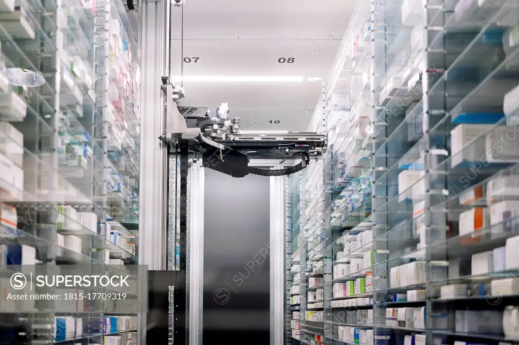 Robotic pharmacy amidst shelves in hospital