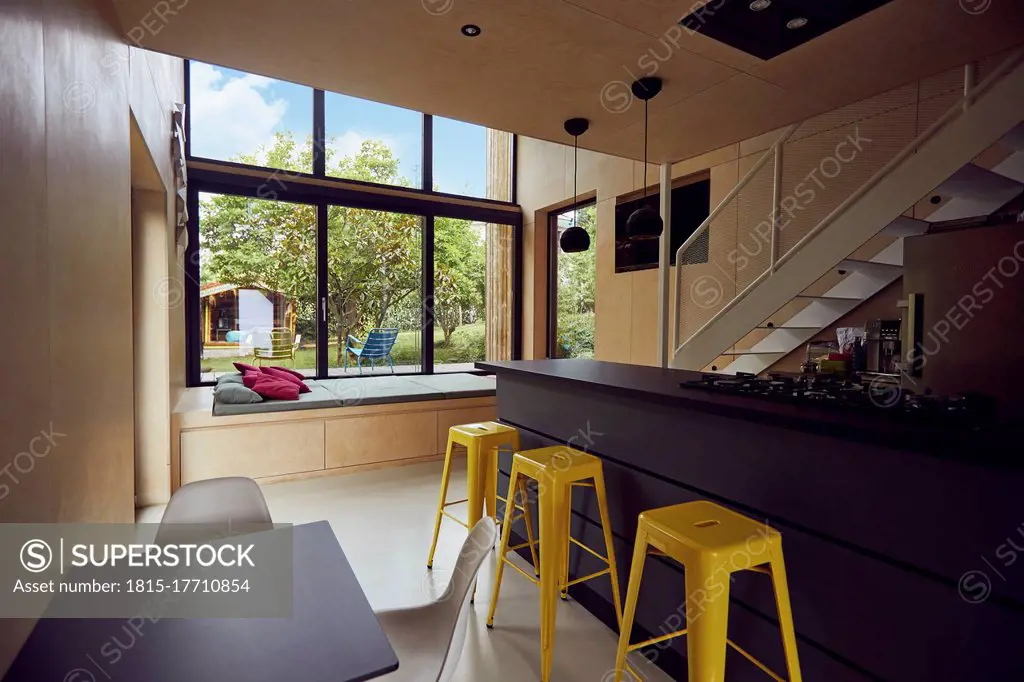 Empty yellow stools by kitchen counter in tiny house