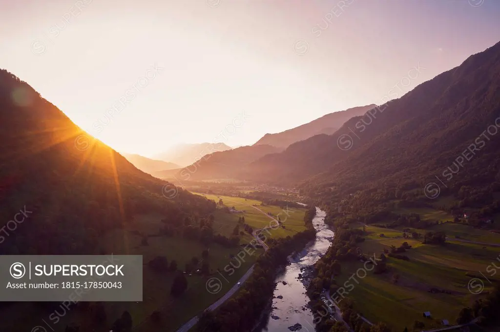 Aerial view of Soca river and mountains against sky during sunset, Gabrje, Slovenia