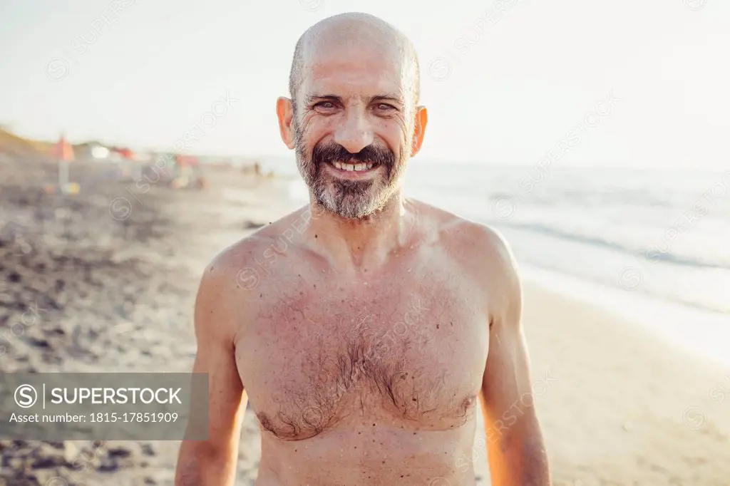 Smiling man standing at beach