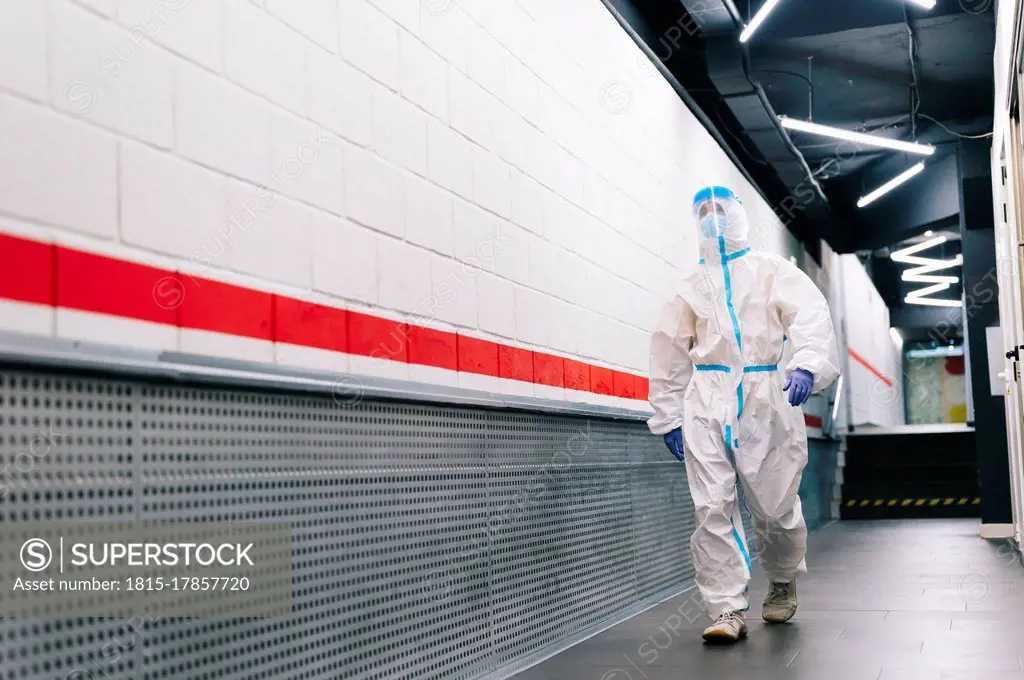 Man walking with face shield in corridor at hospital